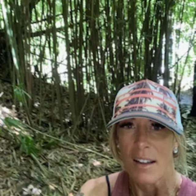 Travel Advisor Tiffany Barney wearing a P cap outdoors in front of a tree.