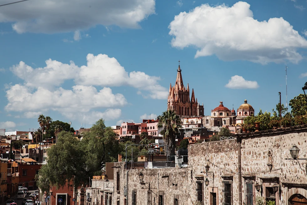 stone wall with buildings in the background during daytime