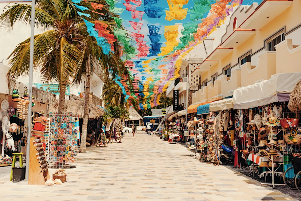 walkway with flags hanging during daytime