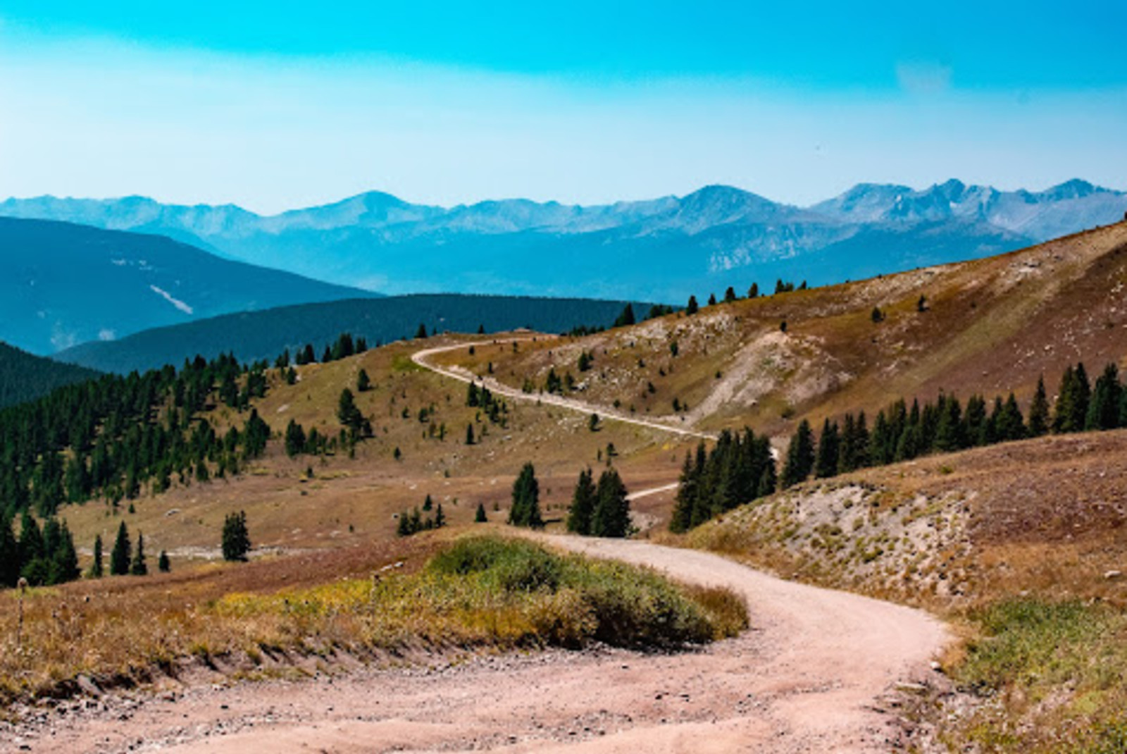 road winding on mountainside during daytime