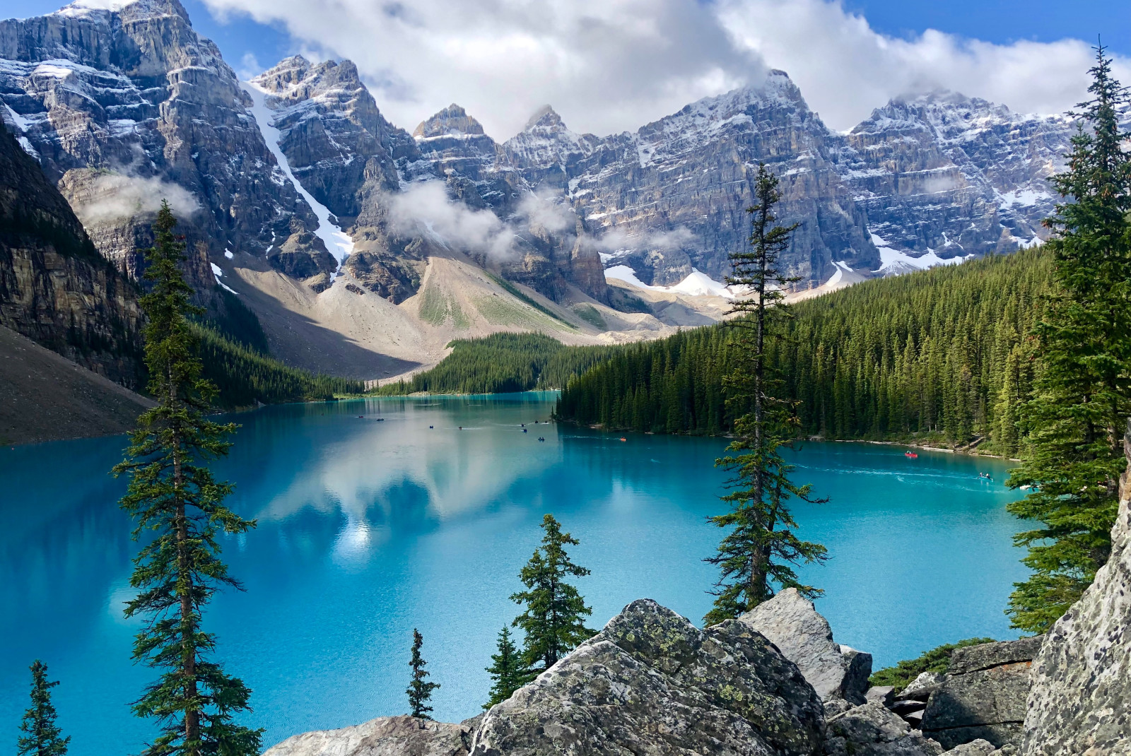 Blue water with mountains in the background during daytime