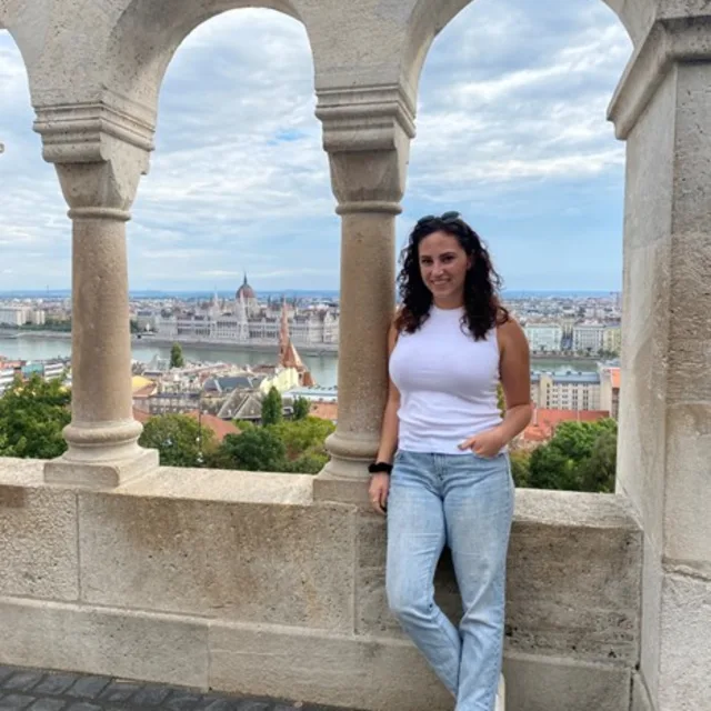 travel advisor Victoria Lee leaning against a stone archway