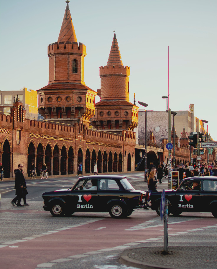 Yellow building and cars with pedestrians in Berlin