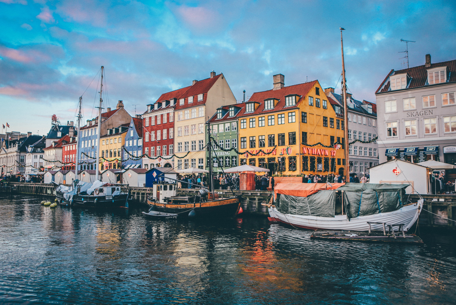 Colorful houses next to body of water during sunset