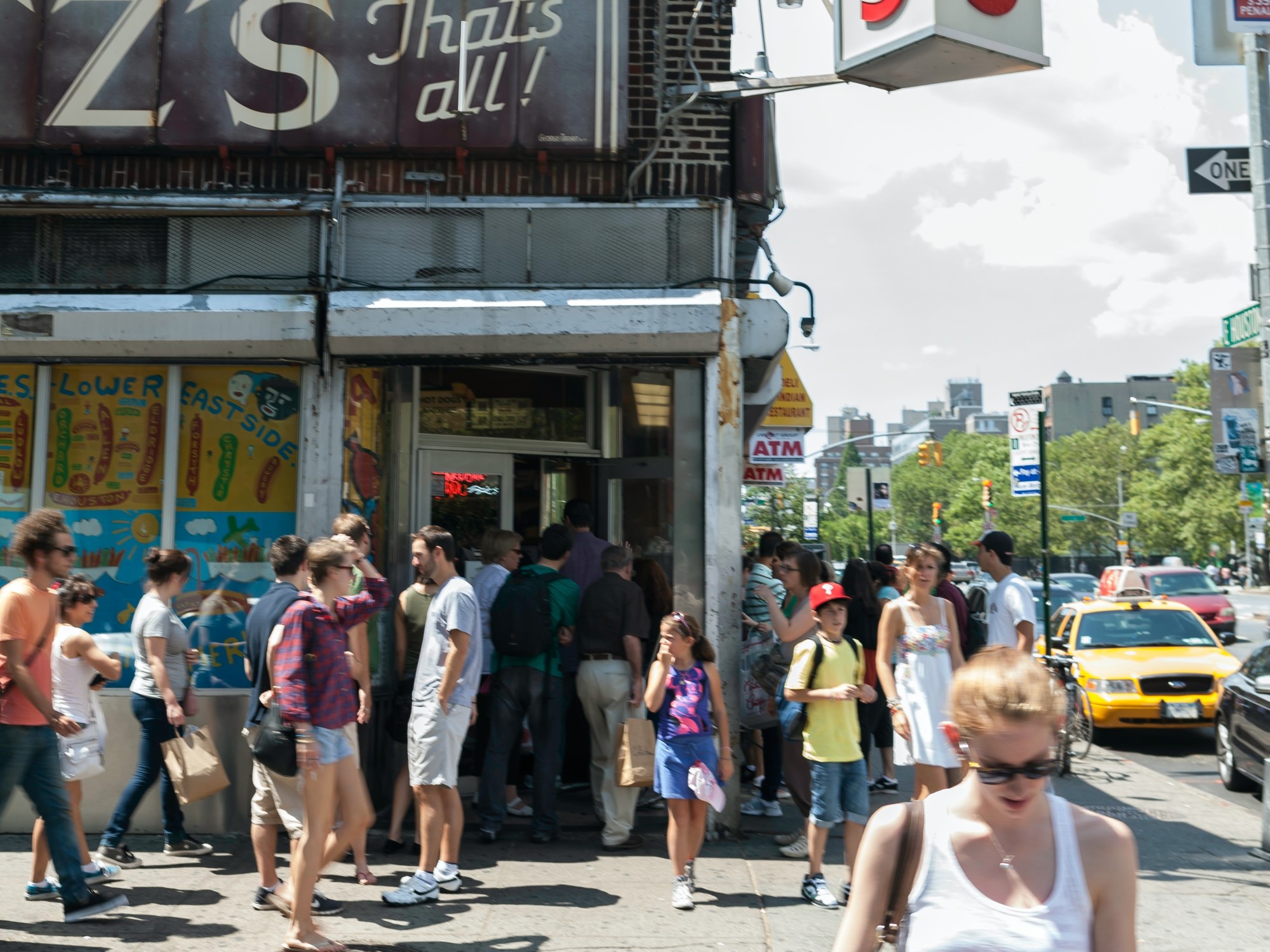 People outside a restaurant during daytime.