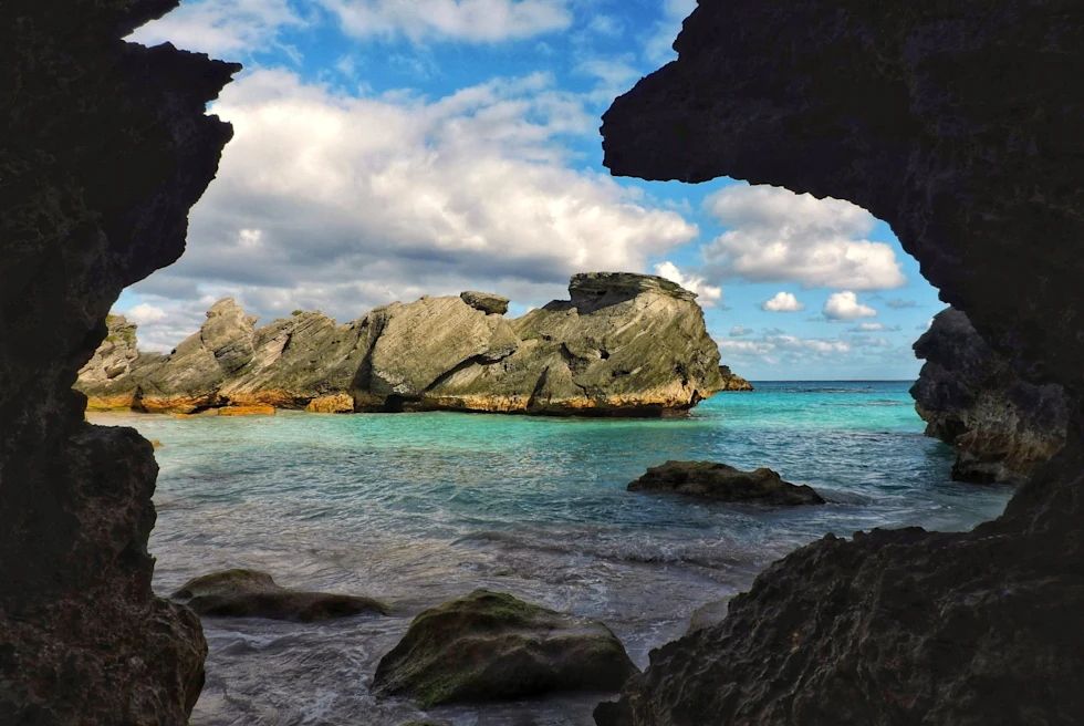 blue sea viewed from a dark cave