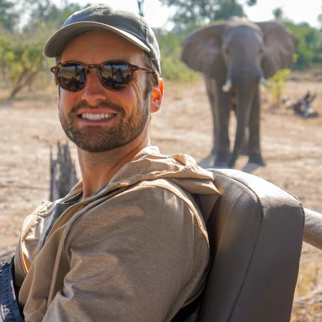 Travel advisor posing in front of an elephant