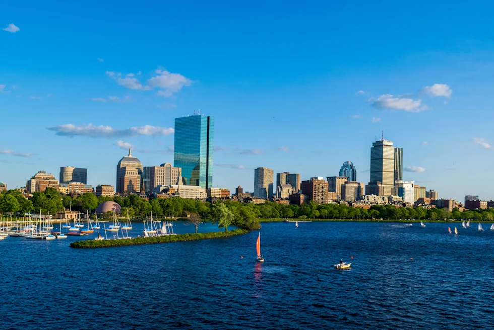 Body of water with city skyline in the background on a sunny day