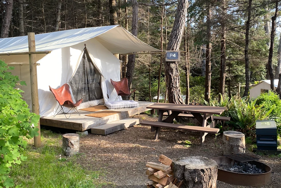 White camp with maroon camping chairs.