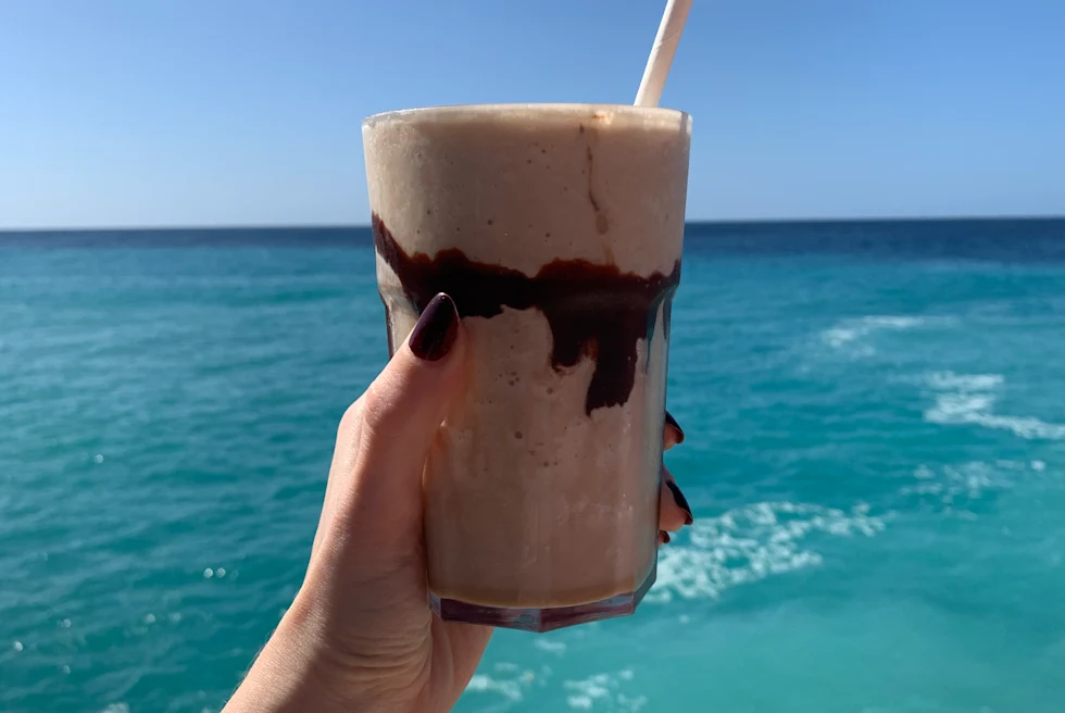 Dirty banana drink in Jamaica in front of the ocean