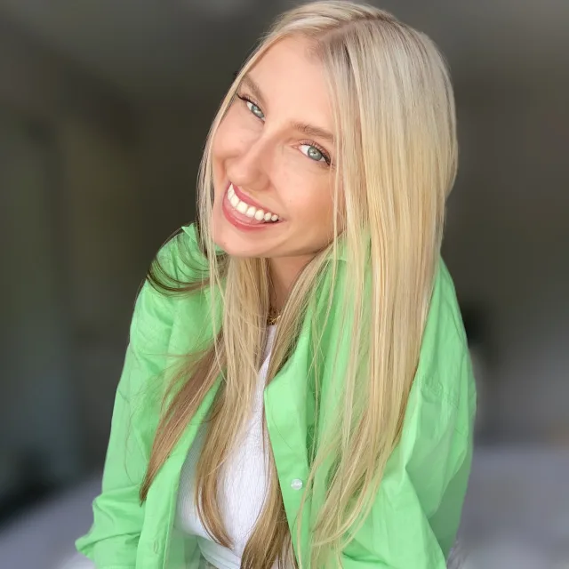 Olga Sergeyev smiling in a green shirt