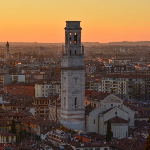 White concrete tower in city during sunset