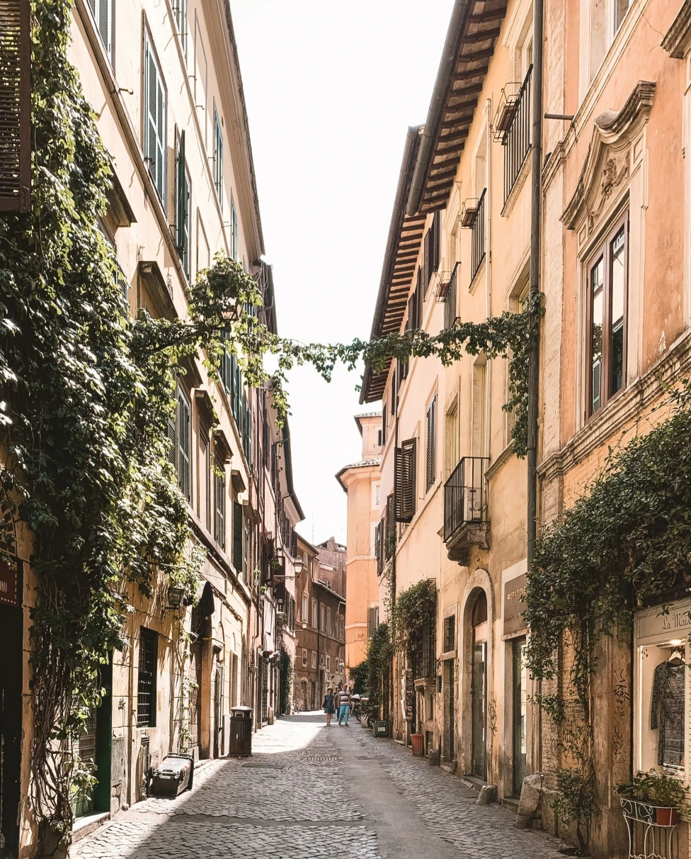 a small empty street in a historic city with ivy covered buildings 