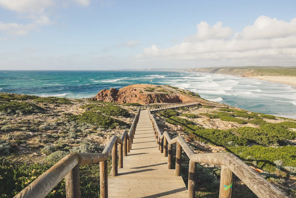 stairs leading down to ocean during daytime