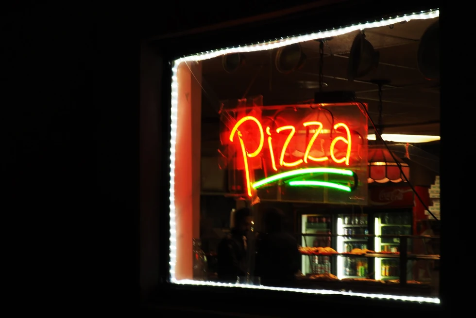A restaurant with pizza sign.