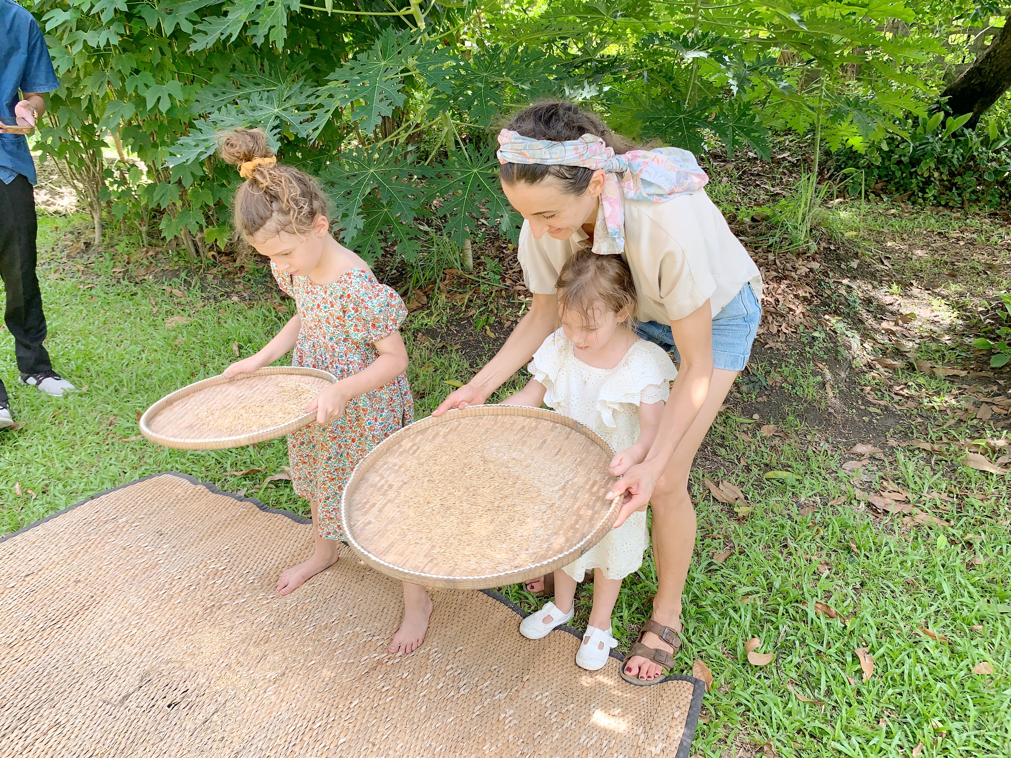 woman standing with two kids during daytime