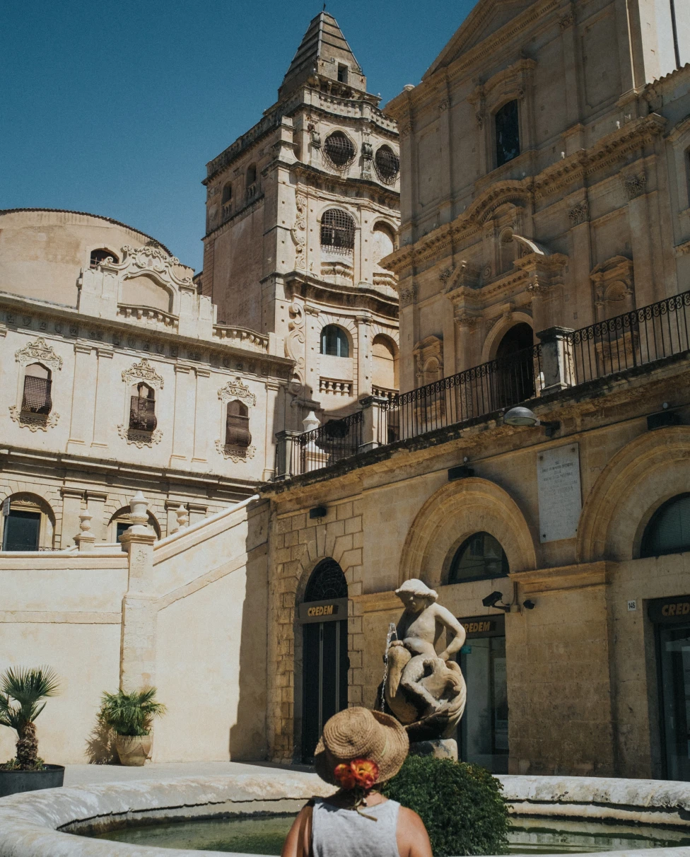 woman standing next to large building during daytime