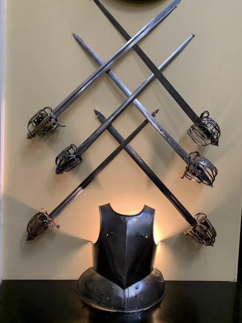 iron swords displayed on a wall 