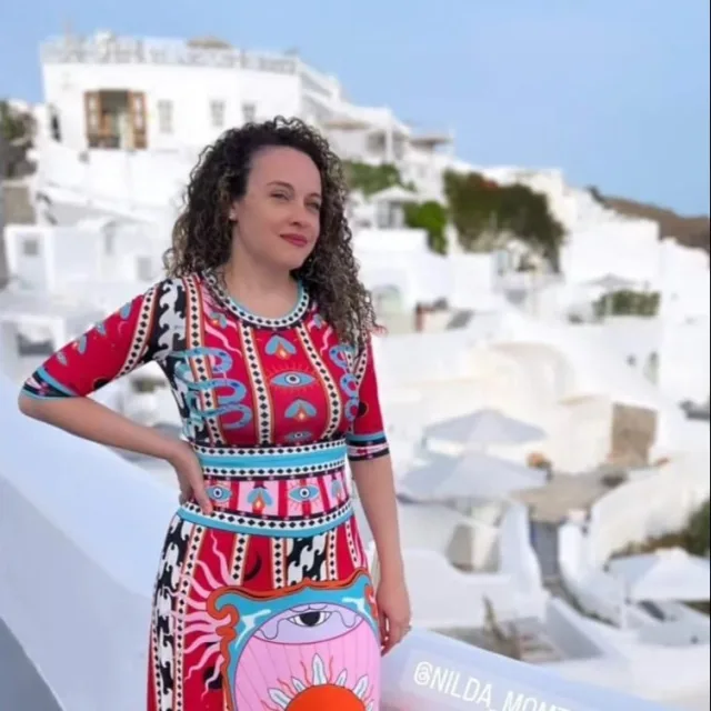 Travel advisor Nilda posing in multi-colored dress in Greece