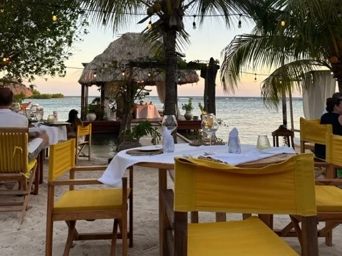 Outdoor restaurant sitting by beach side. 