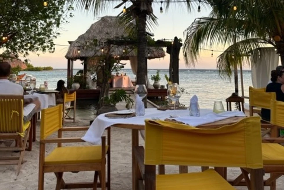 Outdoor restaurant sitting by beach side.