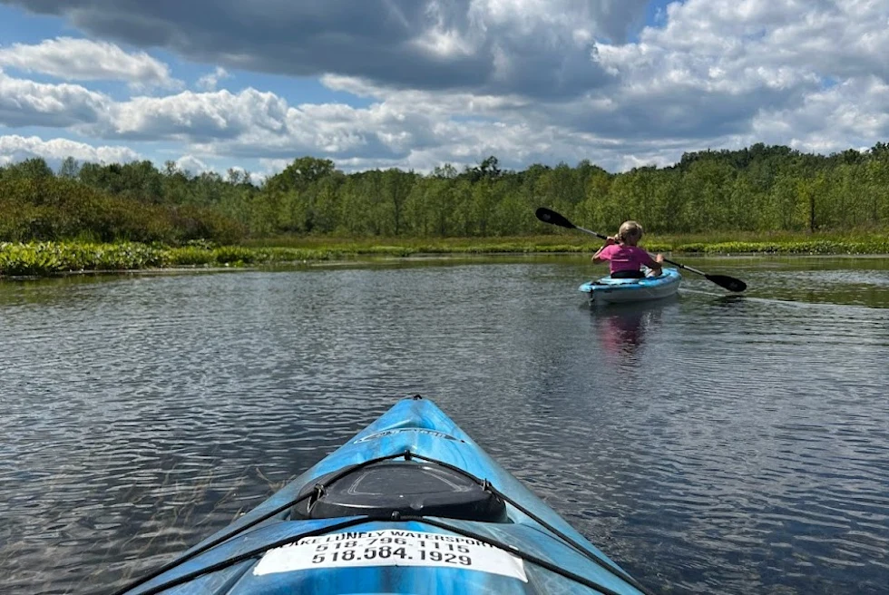 A picture of people on a canoe.