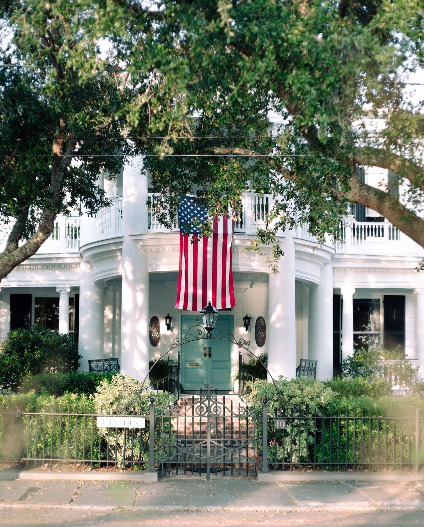 large white building with American flag and trees during daytime