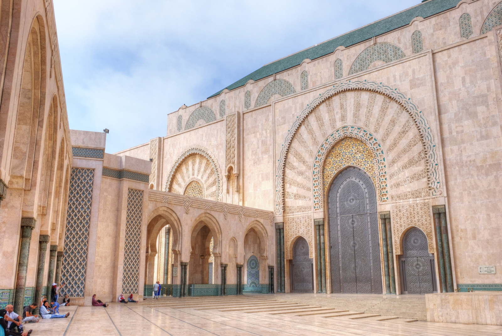 Large stone building with archways during daytime