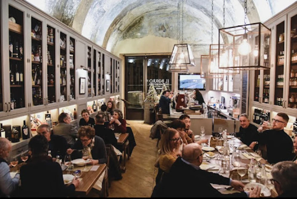 people sitting at tables in a busy restaurant