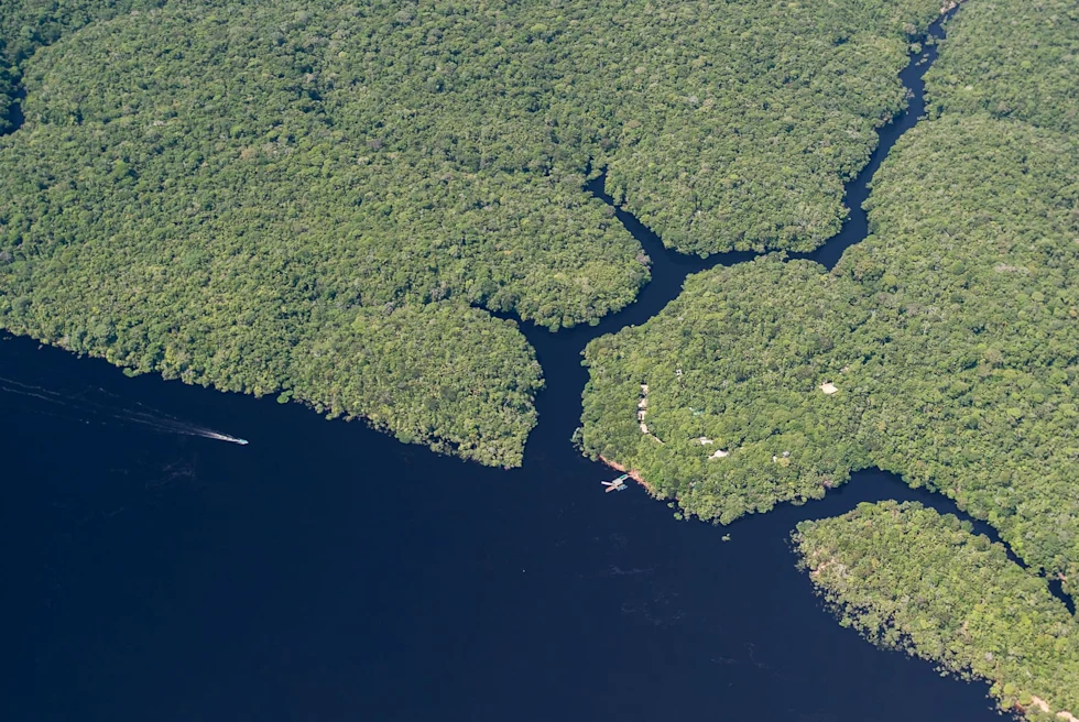 the view from a plane of an archipelago with navy blue water