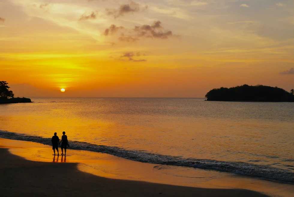 two people on the beach during sunset