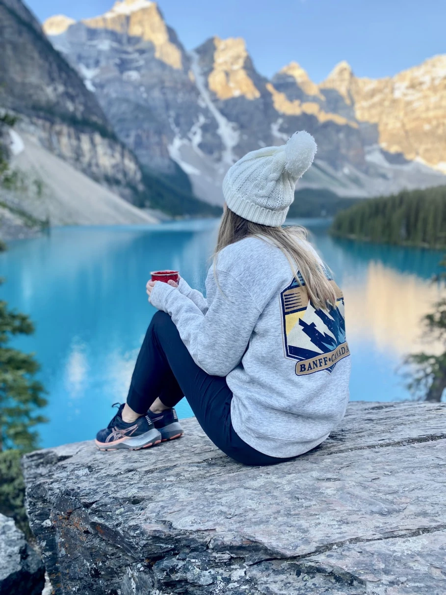 A girl sitting on a Lake in Lake Banff.