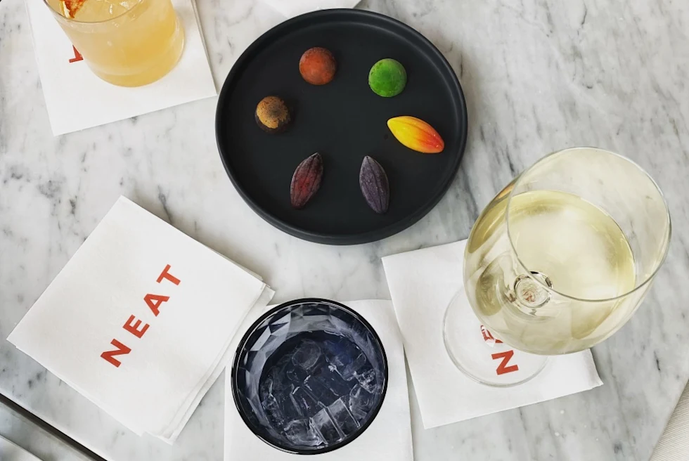 wine glasses and cocktail napkins on a gray table