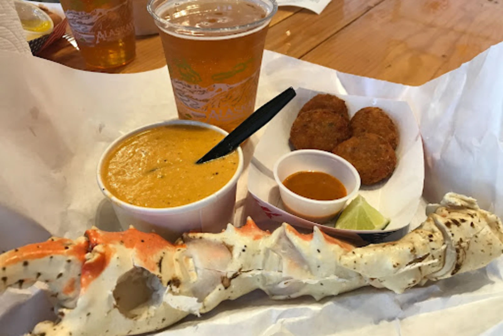 Platter of seafood with cup of soup and cup of beer