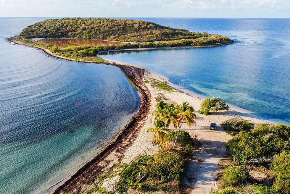 aerial view of two islands in Puerto Rico with blue calm ocean white sand and green palm trees 