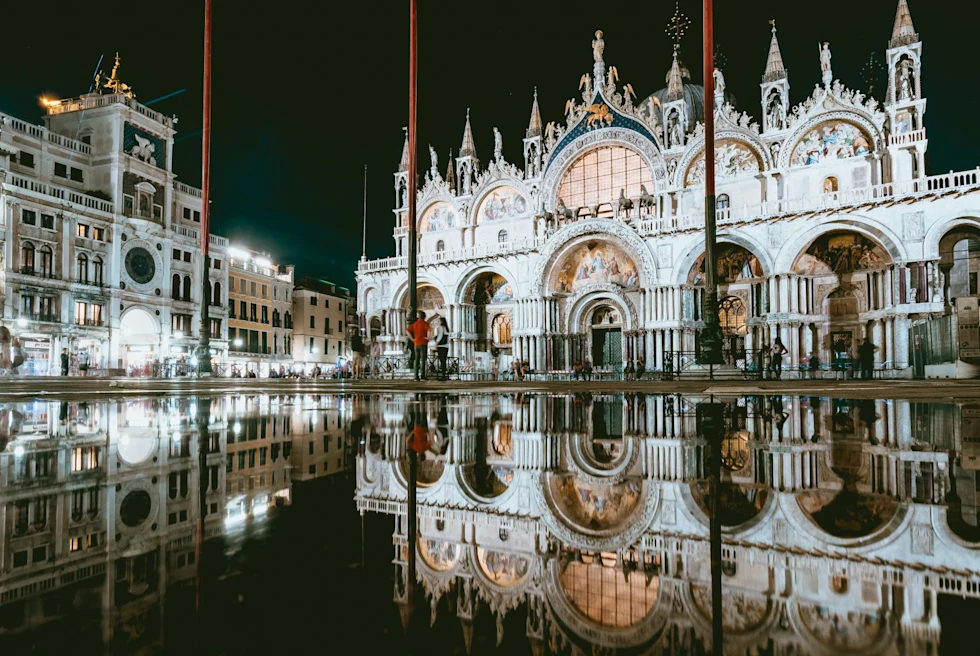 A palace at night with its reflection in water pond.