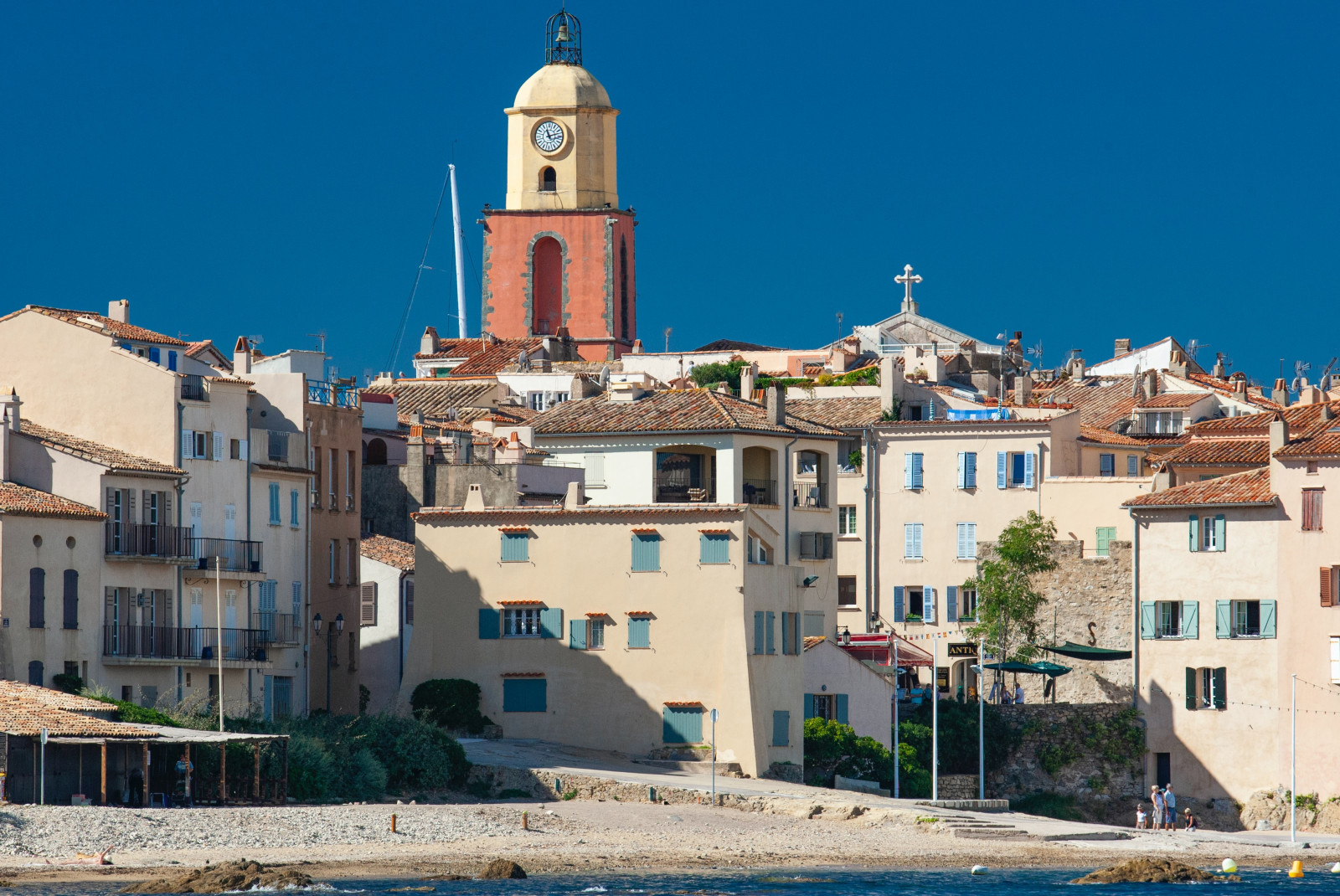 Coastal beach town the the South of France featuring Mediterranean architecture and blue shuttered-windows. 