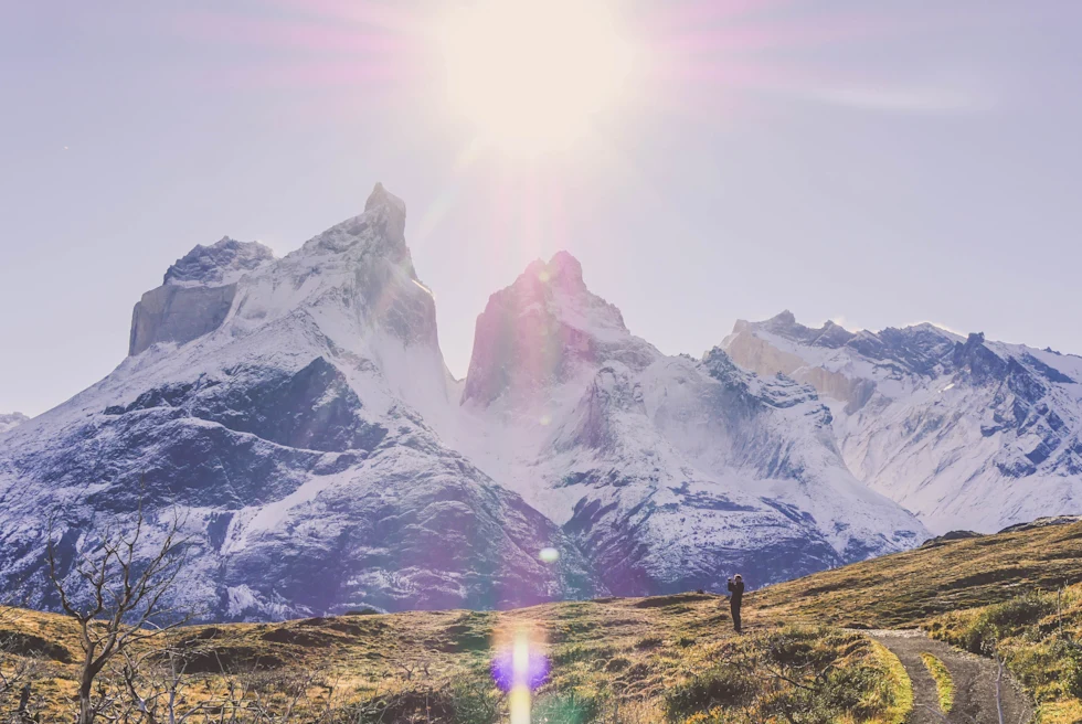 A national park with glass and snowcapped mountains at golden hour.