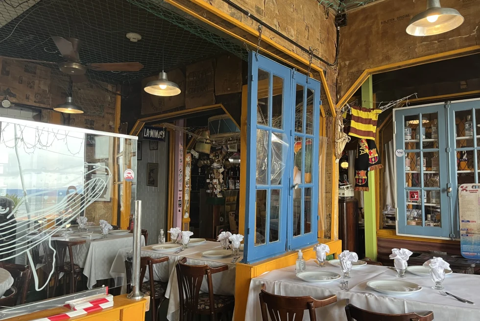 colorful rustic wooden restaurant with white table clothes 