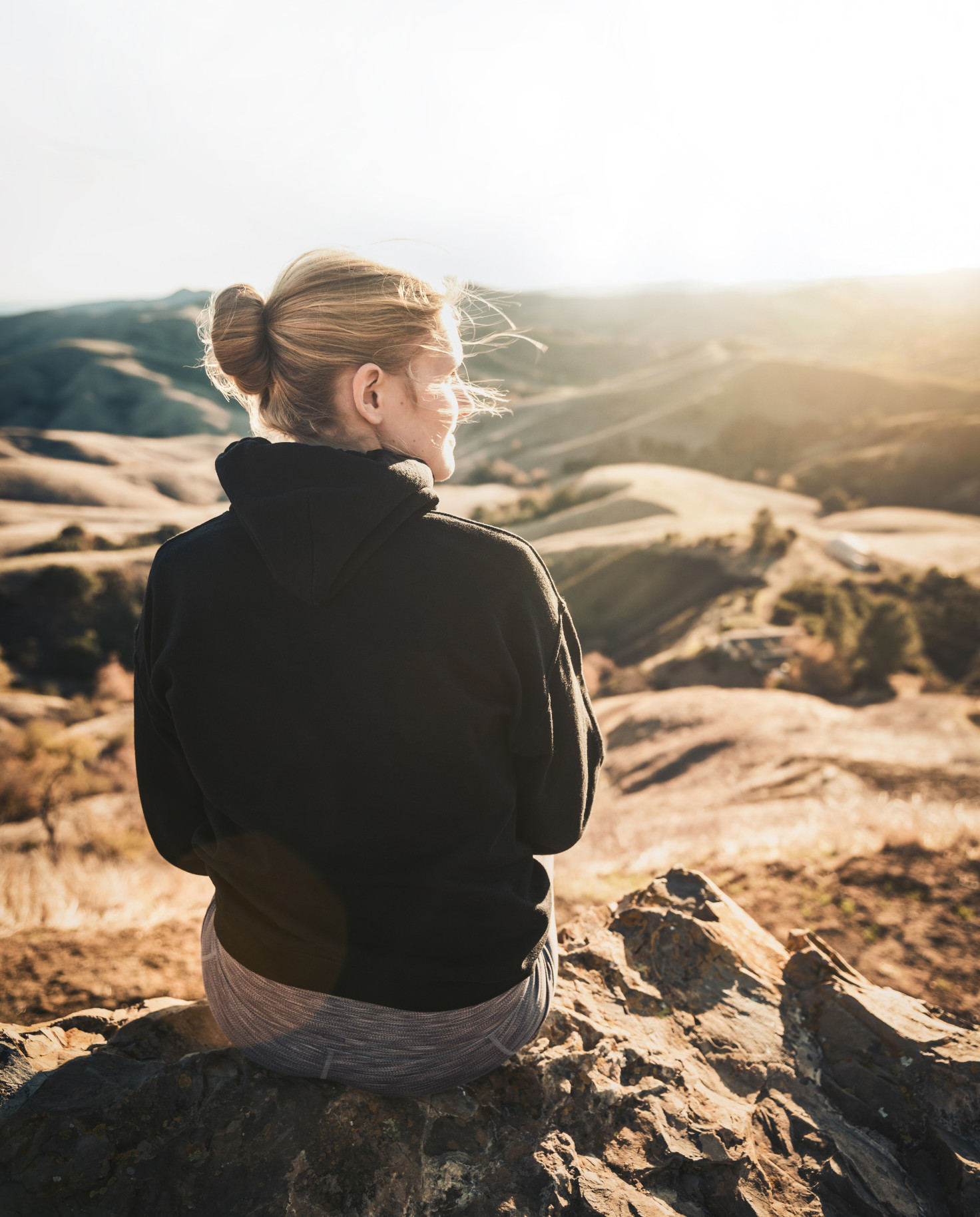 Girl sitting on a mountain. 