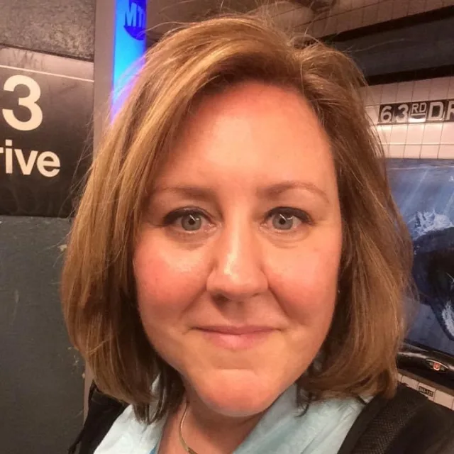 Travel Advisor Holly Virden at a subway station with a blue scarf.