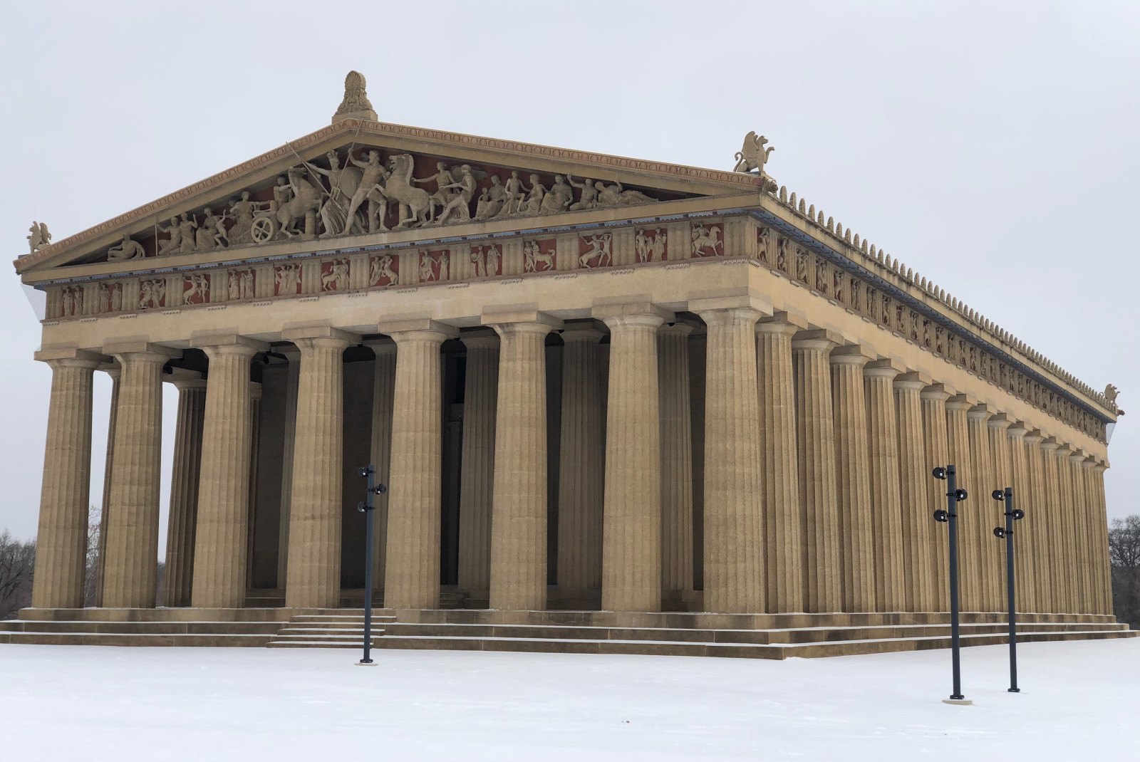 large stone building with cloudy skies