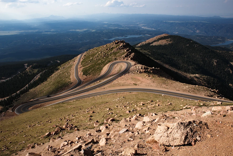 winding road on the side of a mountain during daytime