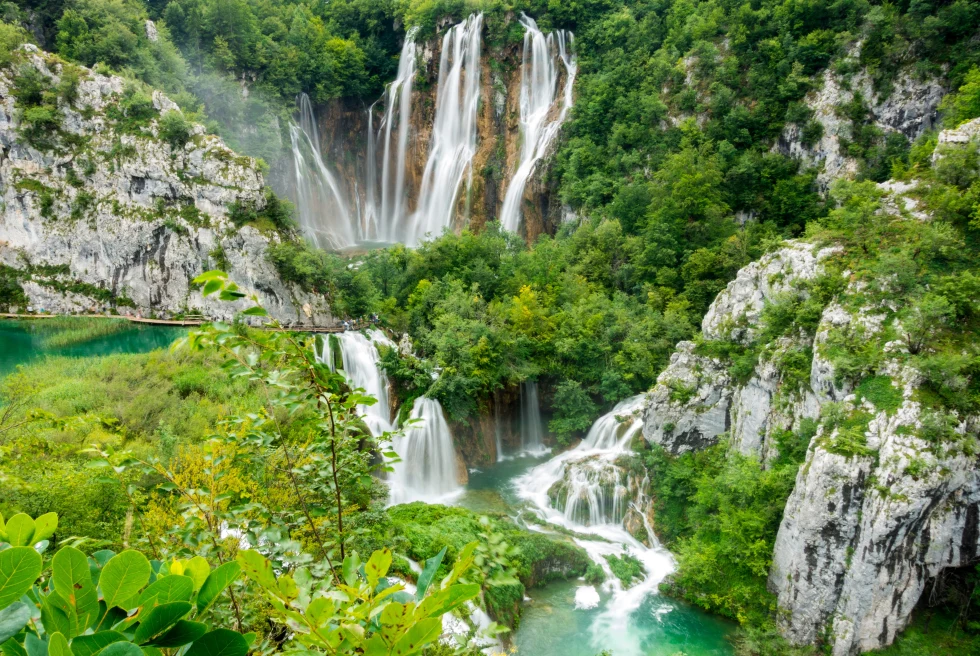Waterfalls amidst a lush, green landscape in Croatia. 