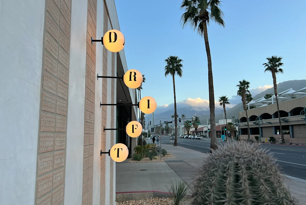 hotel next to street and palm trees during daytime