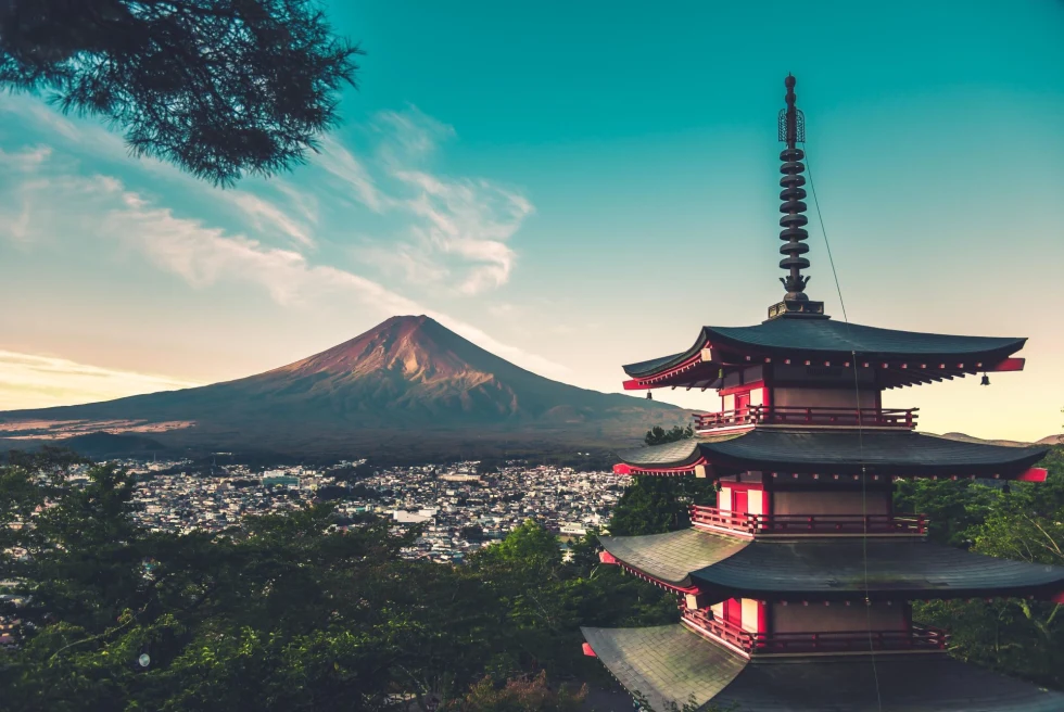 Japanese temple in front of a city and mountain