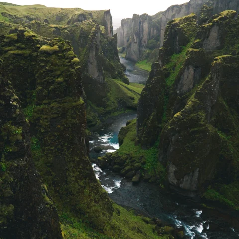 A green canyon with a river int he middle in Iceland.