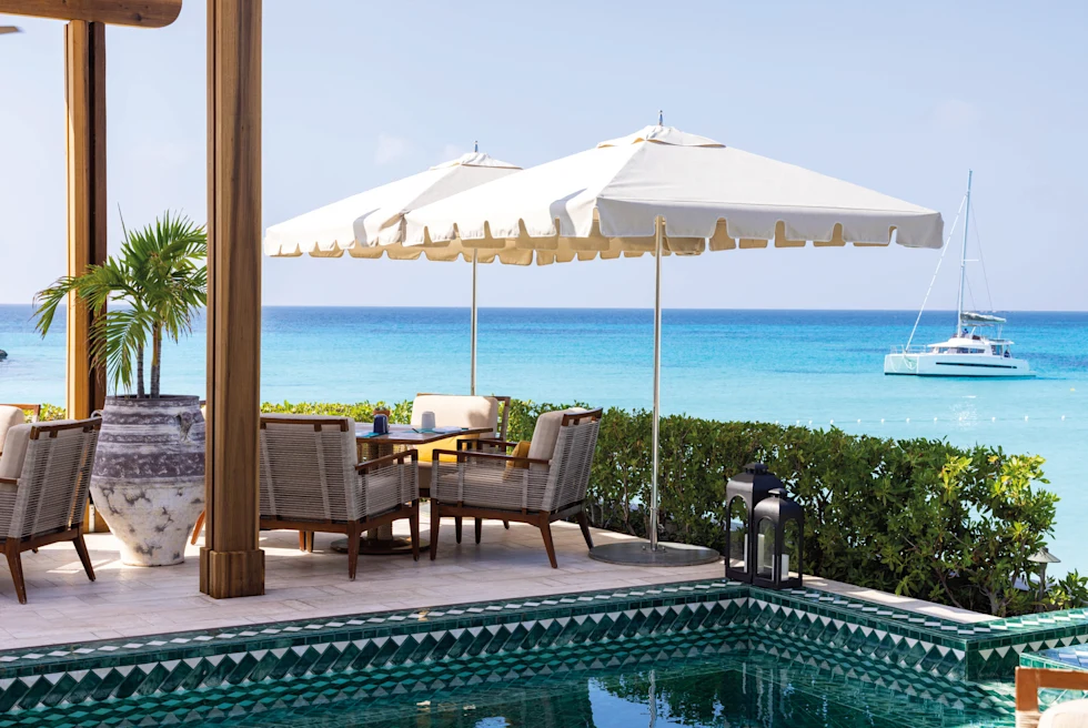 tables and chairs overlooking the ocean during daytime