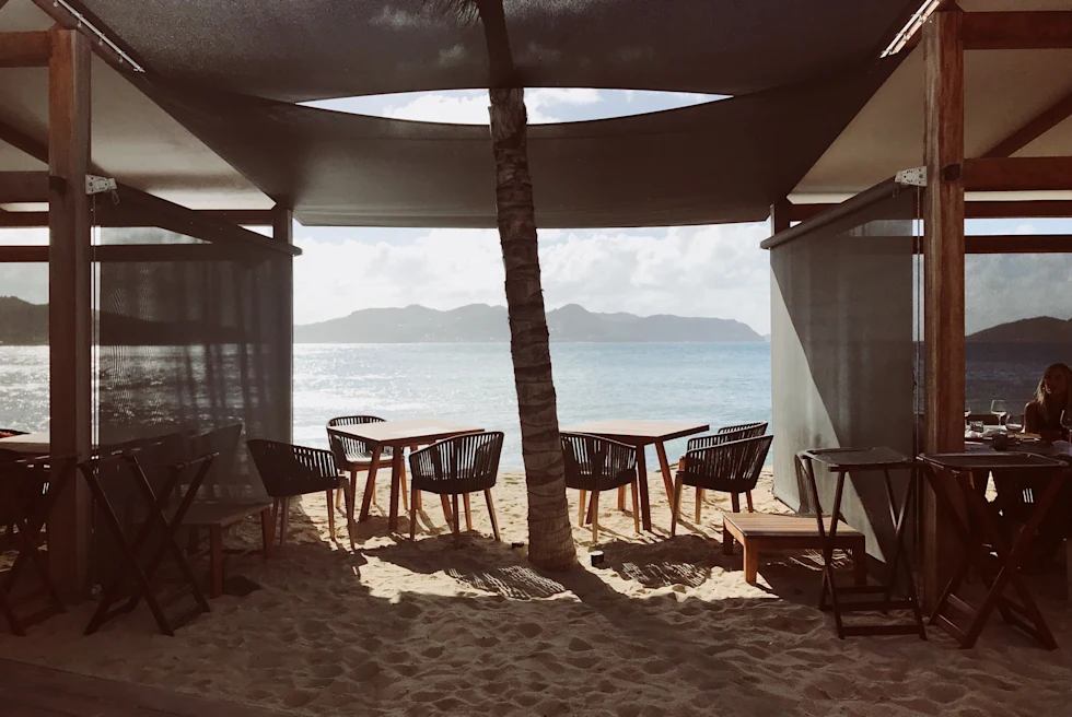 Table and chairs with ocean and mountains in the background