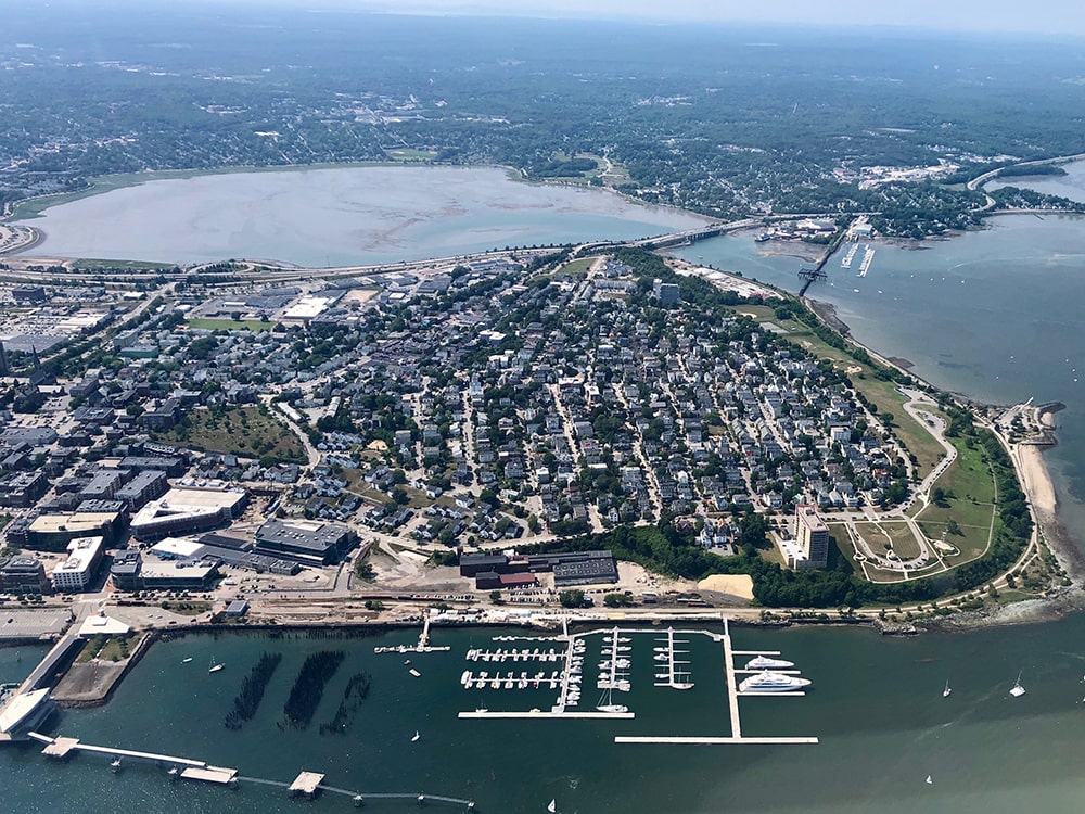 aerial view of buildings next to body of water